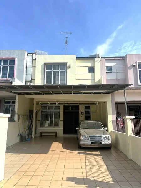 Exterior type: linked terrace house; features: flat roof with awning, cream painted facade, front porch with tiled flooring, single-storey, visible car parked in driveway, metal railing at entrance, windows with shutters, outdoor wall-mounted antenna; style: modern.