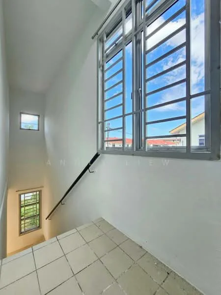 Room features: white painted walls, tile flooring, metal railing, large window with horizontal bars, small window with vertical bars, natural light from windows, staircase leading down; style: modern; view: sky.
