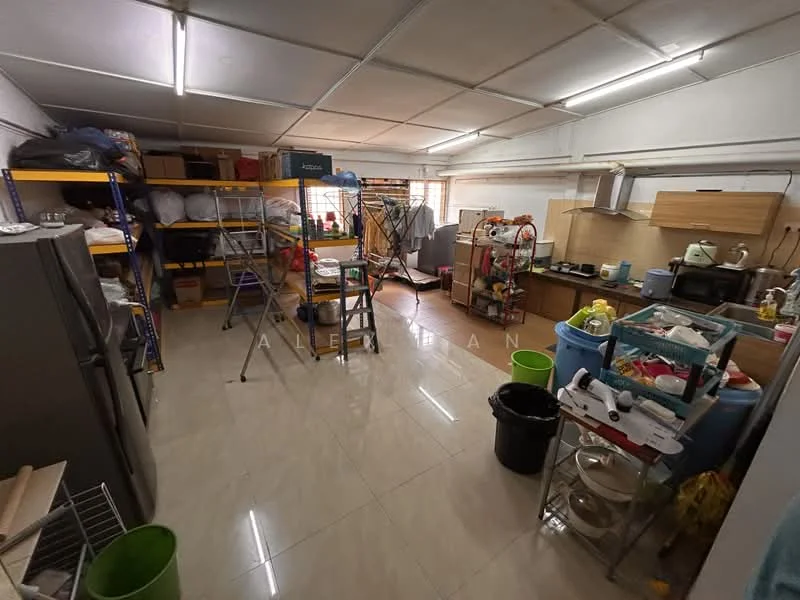 Room features: tile flooring, white painted walls, fluorescent ceiling lights, shelves with storage boxes, metal ladder, refrigerator, kitchen cabinets, sink, various kitchen appliances, plastic bins, cleaning supplies, clothes drying rack; style: functional.