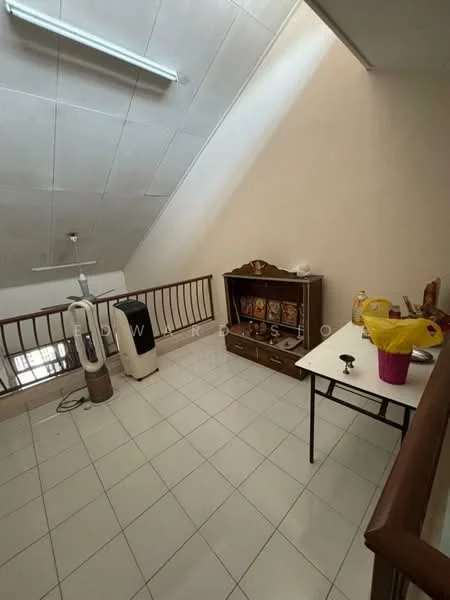 Room features: white painted walls, sloped ceiling, ceiling fan, tiled flooring, wooden railing, wooden cabinet, table, decorative items on cabinet, appliances visible.