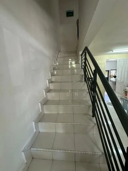 Room features: white painted walls, ceramic tile flooring, metal railing, staircase with white tiles, natural light from upper area.