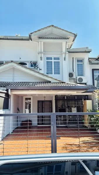 Exterior type: linked terrace house; features: white painted facade, pitched tile roof, two-storey structure, front porch with tiled flooring, metal gate, visible air conditioning units, manicured landscaping, windows with grilles, balcony above the entrance, driveway with interlocking pavers; style: modern.