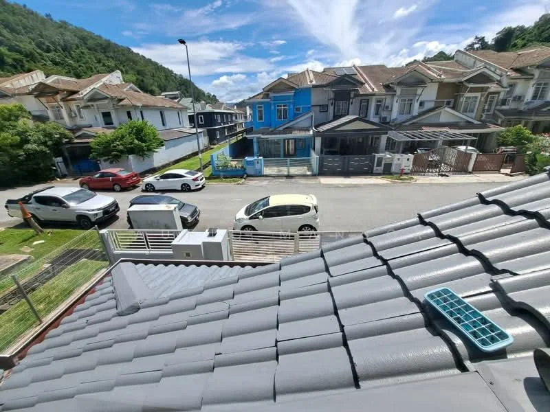 Exterior type: linked terrace house; features: grey tiled roof, two-storey houses, manicured lawn, paved driveway, front yard with low fence, street view with parked cars, surrounded by greenery, blue house in background; style: modern.