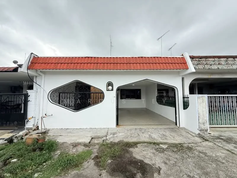 Exterior type: linked terrace house; features: white painted facade, red pitched tile roof, unique geometric window design, front porch area, manicured lawn, concrete pathway, fence with gate, surrounded by greenery; style: modern.