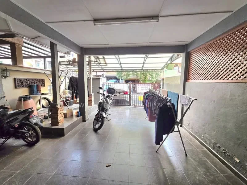 Exterior type: car porch; features: covered car porch, sliding gate, grey tiled flooring, exposed brick wall, clothes drying rack, motorcycle parked, laundry hanging, wooden lattice screen, outdoor lighting; style: modern.