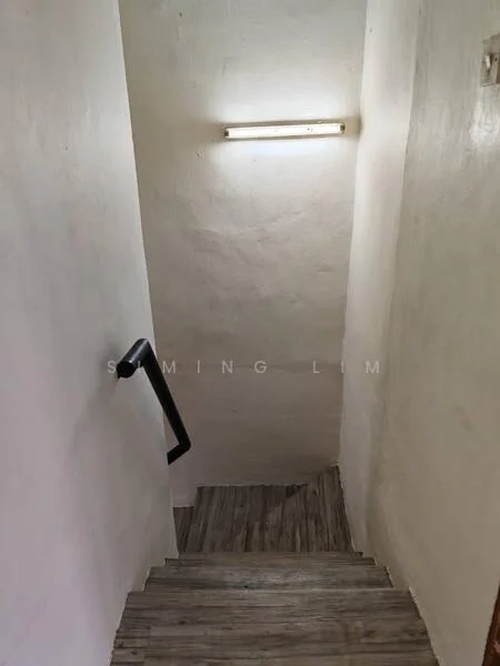 Room features: white painted walls, wooden staircase, handrail, ceiling light fixture.