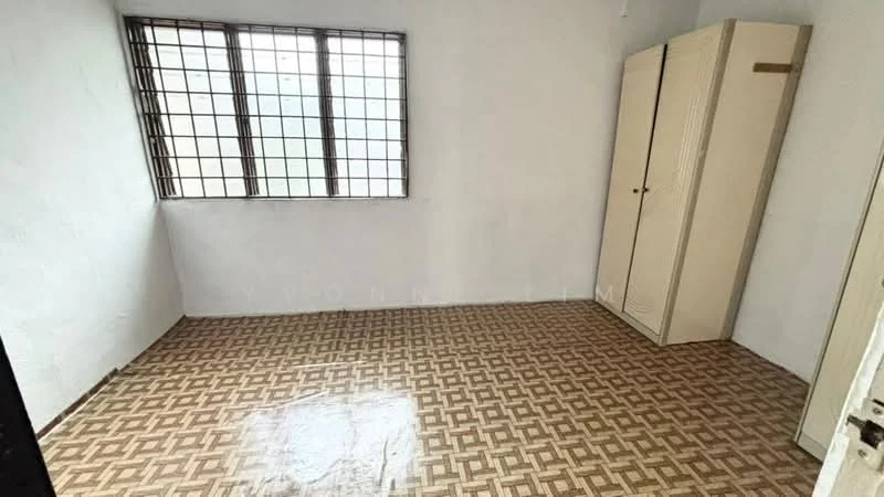 Room features: white painted walls, vinyl flooring with geometric pattern, window with metal grille, built-in wardrobe with sliding doors, single door, natural light from window.