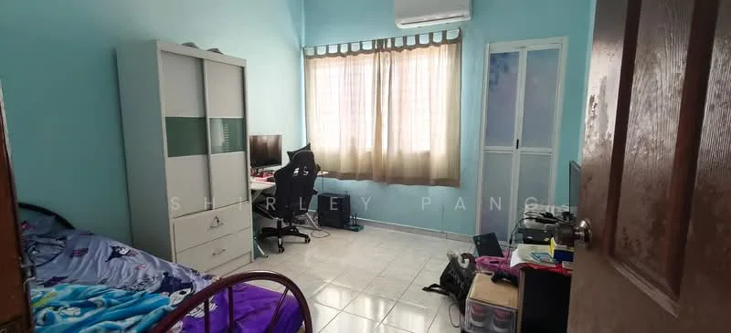 Bedroom features: light blue painted walls, white tiled flooring, single bed with red frame, bedding with cartoon pattern, white wardrobe with glass panels, black office chair, desk with computer monitor, window with sheer curtains, wall-mounted air conditioning unit, decorative items on desk, clothes and personal items on the floor.