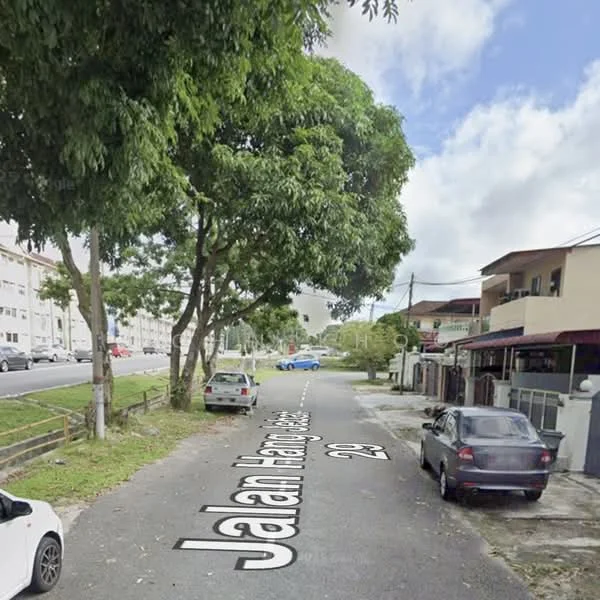 Exterior features: tree-lined street, residential buildings on both sides, paved road, parked cars, sidewalk, street signage.