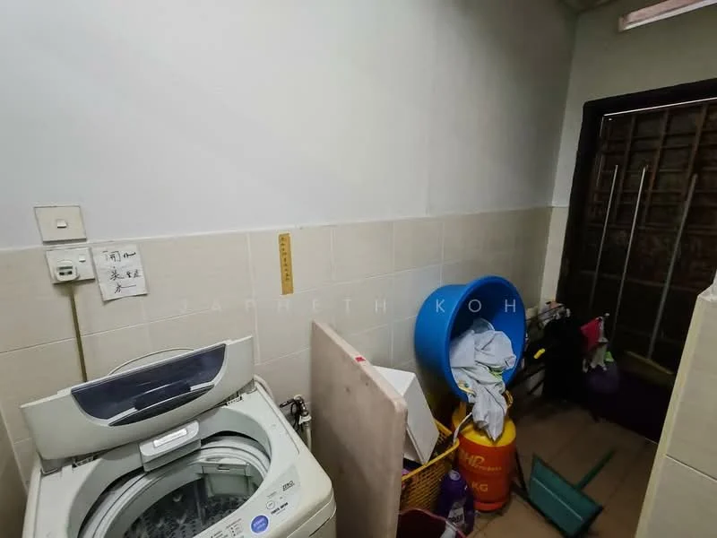 Laundry features: front-load washing machine, tile flooring, white painted walls, window with metal grille, plastic storage bins, cleaning supplies, mop, bucket.