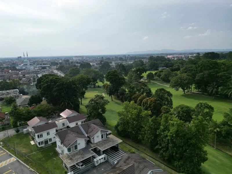 Exterior features: manicured lawn, mature trees, surrounded by greenery, urban context, view of residential area, distant hills, open sky; style: modern.
