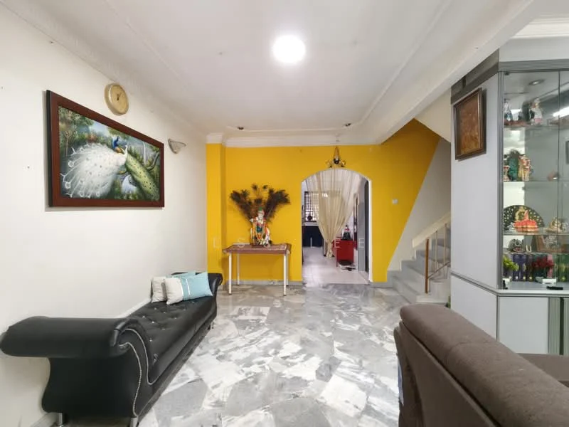 Living features: grey marble flooring, yellow painted accent wall, white painted walls, sofa in black leather, decorative wall art with peacock design, wooden console table, decorative plants on table, staircase with glass railing, recessed ceiling lights, wall-mounted clock; style: modern.
