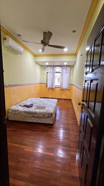 Bedroom features: wooden flooring, yellow painted walls, crown moulding, ceiling fan, air conditioning unit, window with sheer curtains, double bed with floral bedding, nightstand, light fixtures, built-in wardrobe, decorative wall trim; style: traditional.