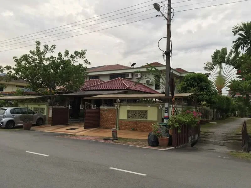 Exterior type: detached bungalow; features: red pitched tile roof, cream painted facade, exposed brick wall, manicured lawn, mature trees, paved driveway, car porch with awning, wall-mounted split AC units, decorative fencing, front garden with plants, street view, surrounded by greenery; style: modern.
