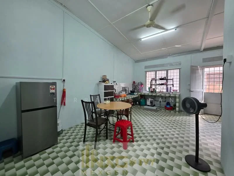 Kitchen features: green and white checkered tile flooring, light blue painted walls, exposed ceiling with beams, ceiling fan, stainless-steel fridge, wooden dining table, black dining chairs, red plastic stool, open shelving, window with metal grille, kitchen countertop, various kitchen appliances on countertop.