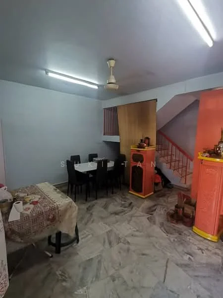 Room features: grey marble flooring, light blue painted walls, ceiling fan, fluorescent lighting, dining table with chairs, staircase, wooden partition, decorative elements on counter.