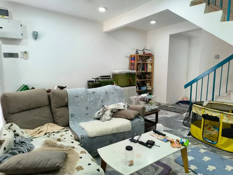 Living features: 2-seater fabric sofa in beige, 3-seater fabric sofa with animal print, coffee table, area rug, bookshelf with various items, wall-mounted light fixtures, white painted walls, laminate flooring, ceiling lights, decorative items on shelves, playpen, miscellaneous items on furniture.