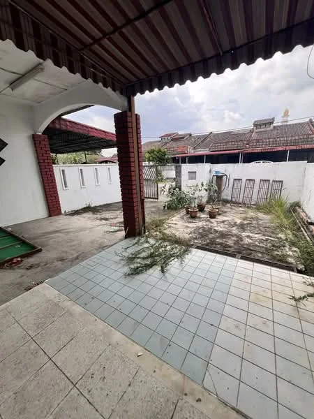 Exterior features: covered patio, tiled flooring, exposed brick columns, white painted walls, fenced yard, overgrown grass, potted plants, concrete surface, open space, roof overhang.