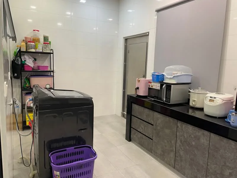 Laundry features: black washing machine, grey cabinetry, white countertop, microwave, rice cooker, pink storage container, purple laundry basket, open shelving with various containers, white tiled walls, grey tiled flooring; style: modern.