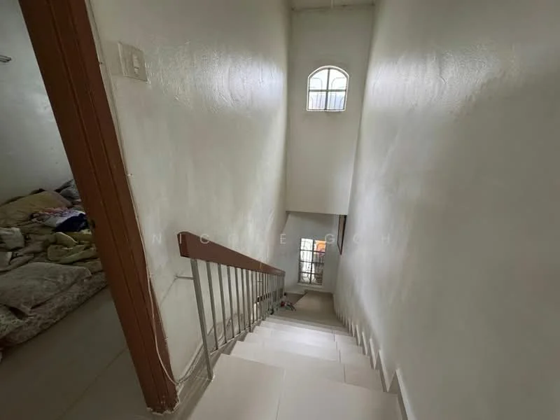 Room features: white painted walls, tile flooring, staircase with metal railing, window with arch design, natural light from window, carpeted area at bottom of stairs.