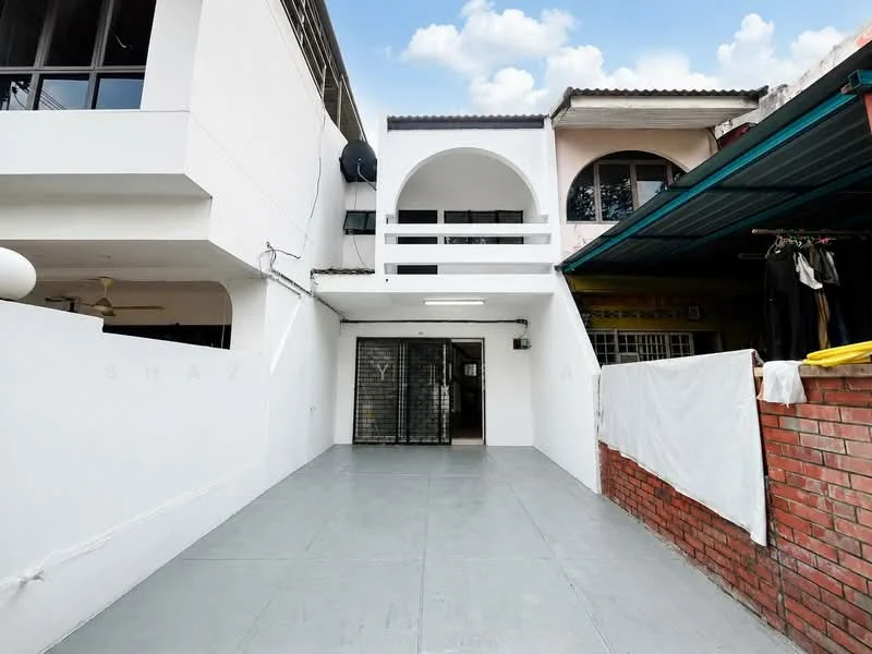 Exterior type: linked terrace house; features: white painted facade, arched entrance, grey tiled flooring, covered car porch, brick wall, laundry area with white sheet, windows with black frames, overhang roof, outdoor lighting, surrounding greenery; style: modern.