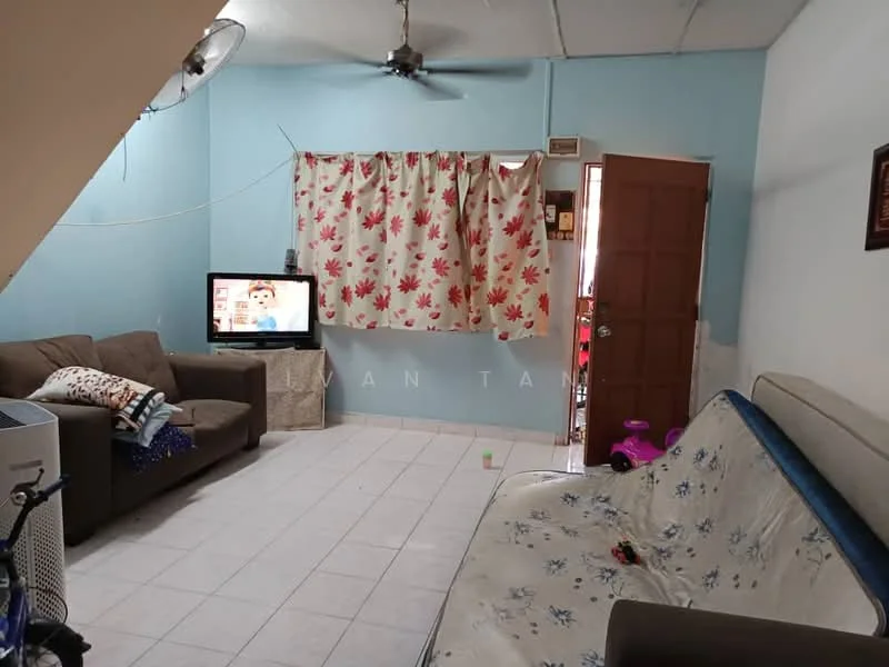 Living features: light blue painted walls, white tiled flooring, 3-seater fabric sofa in brown, 2-seater fabric sofa with floral pattern, ceiling fan, curtains with floral pattern, wall-mounted TV, wooden door, decorative wall frame, area rug, basket with toys.