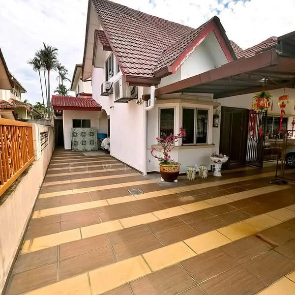Exterior type: semi-detached house; features: red tiled roof, white painted facade, paved walkway, landscaped garden with potted plants, car porch with awning, air conditioning units visible, decorative wall with wooden railing, outdoor seating area, windows with grills; style: modern.