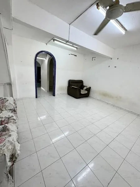 Living features: white painted walls, white tiled flooring, ceiling fan, sofa in brown fabric, arched doorway, fluorescent ceiling lights.