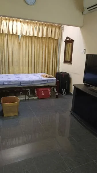 Room features: grey tiled flooring, cream painted walls, curtains in beige, single bed with mattress, wall-mounted mirror, television on black TV cabinet, basket for storage, luggage, air conditioning unit.