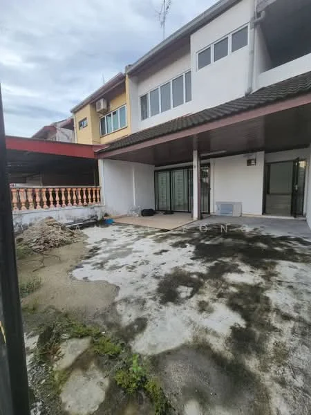 Exterior type: semi-detached house; features: two-storey structure, concrete flooring, exposed aggregate concrete, glass sliding doors, balcony with railing, air conditioning unit, partially landscaped garden, paved patio area, visible drainage, surrounding wall, roof overhang; style: modern.