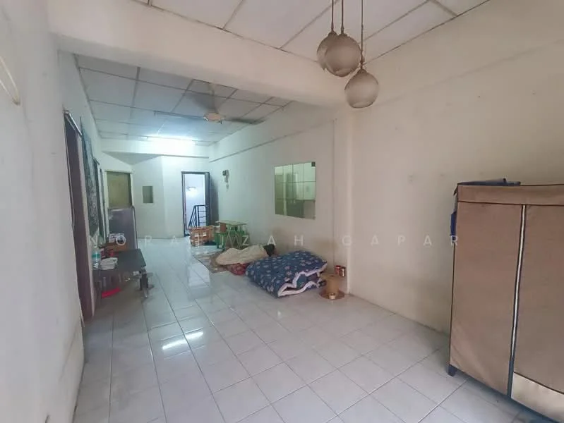 Room features: white painted walls, white tiled flooring, ceiling fan, hanging pendant lights, large mirror on wall, foldable fabric wardrobe, blue patterned bedding, seating area with cushions; style: minimalist.