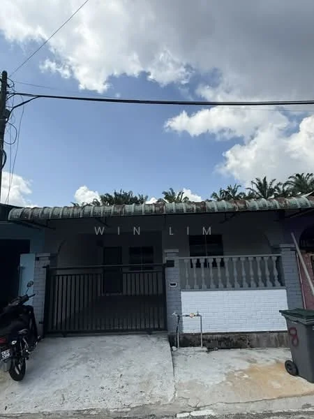 Exterior type: semi-detached house; features: white painted facade, flat roof, single-storey, manicured lawn, front gate, paved driveway, visible palm trees in background, metal railing at entrance; style: traditional.
