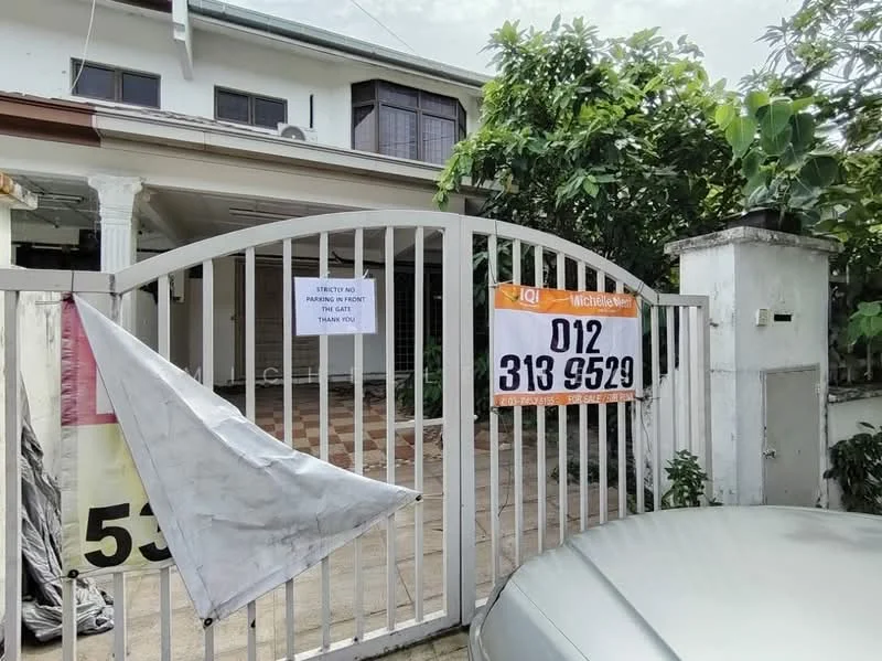 Exterior type: detached bungalow; features: white painted facade, gated entrance, paved driveway, front garden with greenery, single-storey, porch area, visible house number, signage for real estate listing; style: modern.