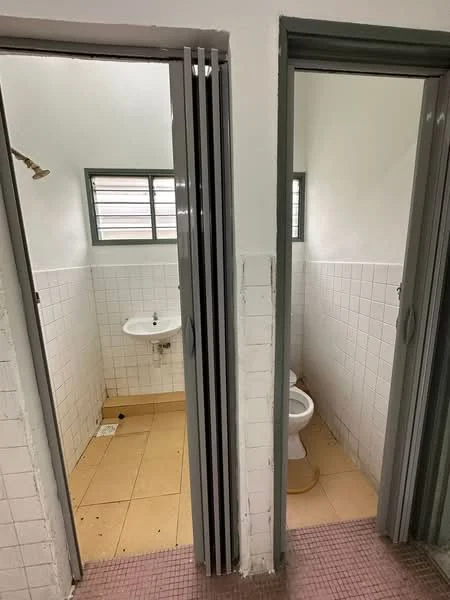 Bathroom1 features: shower head, white tiled walls, yellow floor tiles, sink, window, exposed plumbing. Bathroom2 features: toilet, white tiled walls, yellow floor tiles, window, exposed plumbing.