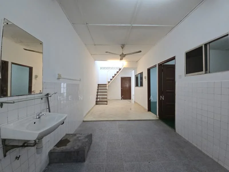 Room features: white painted walls, grey tiled flooring, ceiling fan, staircase leading to upper floor, wooden doors, windows with glass panes, sink with wall-mounted mirror, open layout; style: minimalist.