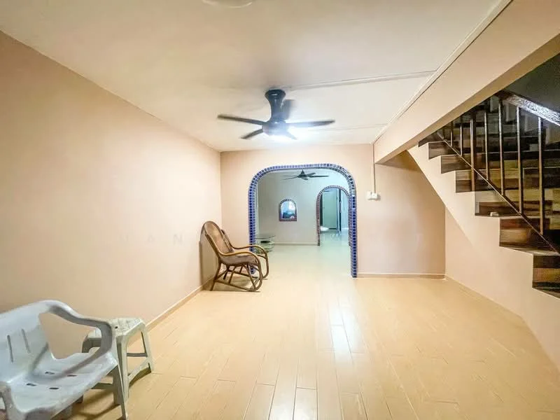 Room features: light brown painted walls, laminate flooring, 5-blade ceiling fan, arched doorway, staircase, wooden railing, reclining chair, plastic chair; style: traditional.