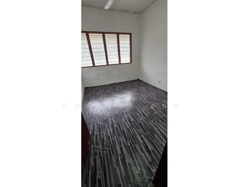 Room features: grey laminate flooring, white painted walls, large windows with grid pattern, ceiling with fluorescent lighting.
