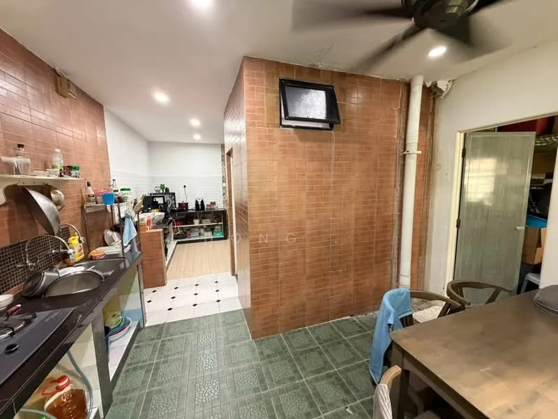 Kitchen features: brown tiled walls, green ceramic tile flooring, wall-mounted split AC, stainless-steel sink, 4-burner gas hob, exhaust hood, kitchen cabinets, dining table, ceiling fan, open shelving. Room features: white walls, doorway leading to another room, light fixtures.