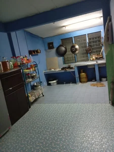 Kitchen features: blue painted walls, vinyl tile flooring, stainless-steel fridge, metal shelving unit, cooking stove, kitchen countertop, sink, window with metal grilles, ceiling lights, exhaust fan.