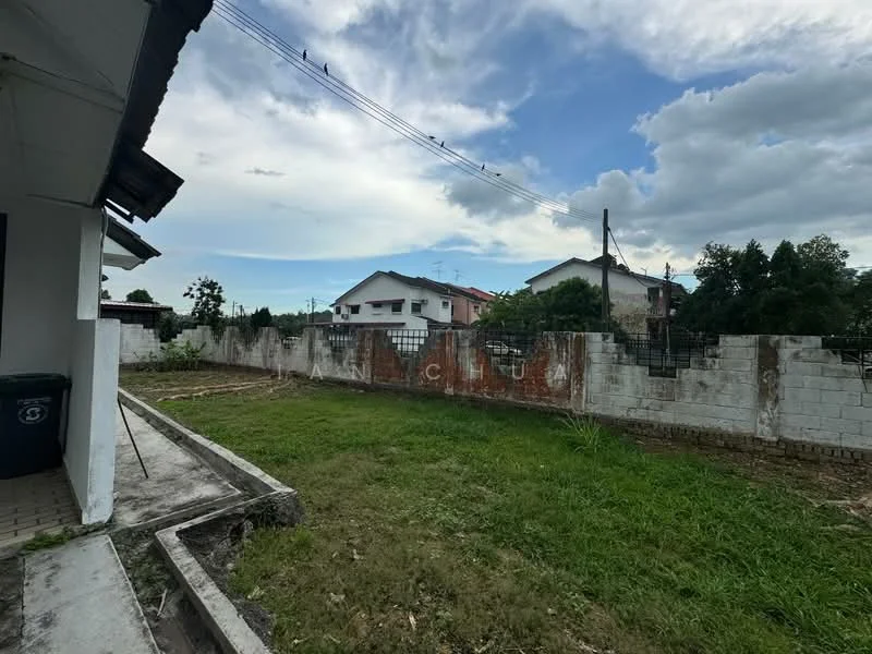 Exterior features: fenced yard, grass lawn, concrete pathway, adjacent residential buildings, partially cloudy sky, utility poles, exposed brick wall, landscaped area.