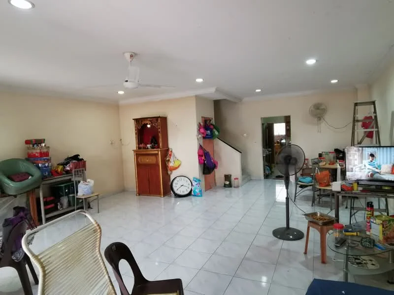 Living features: white painted walls, glossy white tile flooring, ceiling fan, recessed downlights, wall-mounted TV, wooden cabinet, various chairs, round table, decorative wall clock, staircase visible, air conditioning unit, various household items scattered.
