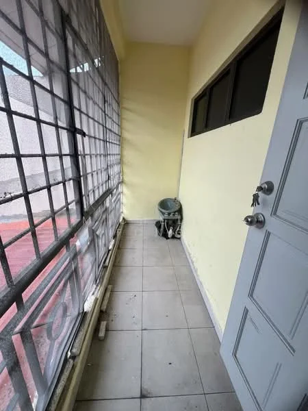 Room features: yellow painted walls, grey tiled flooring, large window with metal grille, door with handle, corner plant pot.
