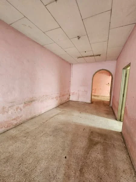Room features: pink painted walls, concrete flooring, arched doorway, drop ceiling, no visible windows, no visible lighting fixtures.