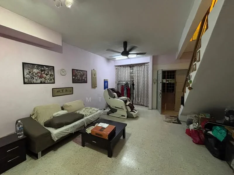 Living features: light pink painted walls, exposed concrete flooring, 5-blade ceiling fan, sofa with cushions, coffee table, framed artwork on walls, curtains, clothes rack, staircase leading to upper level, decorative wall clock; style: modern.