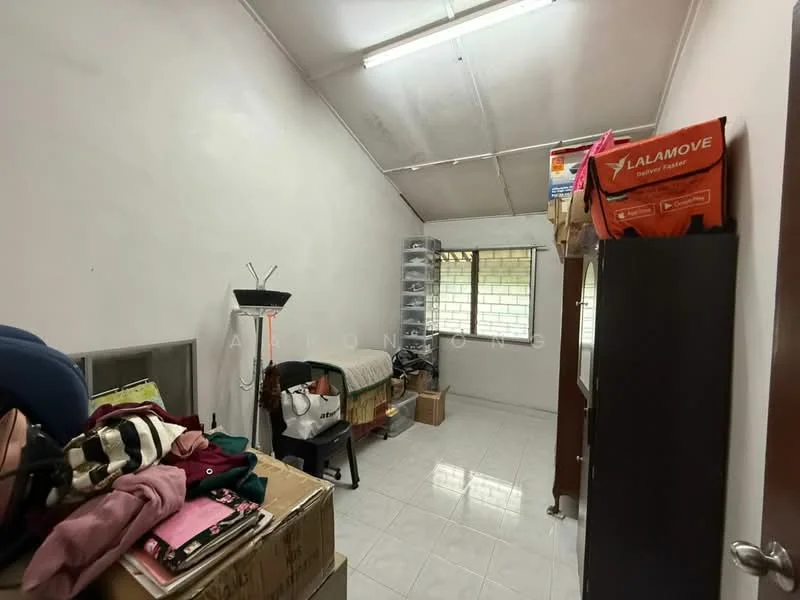 Room features: white painted walls, sloped ceiling, tile flooring, window with grid pattern, built-in shelving unit, clothes rack, various boxes and bags, bed with bedding.