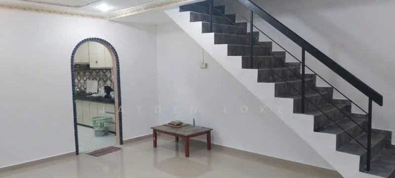 Room features: staircase with black metal railing, white painted walls, grey tiled flooring, arched doorway, recessed ceiling lights, small coffee table, kitchen visible in background, kitchen with tiled backsplash; style: modern.