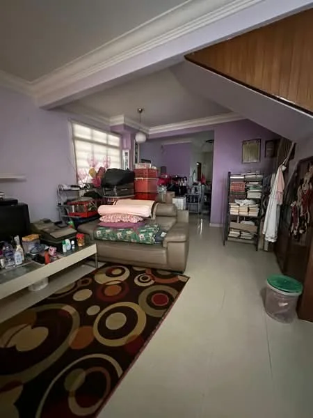 Living features: purple painted walls, white ceiling with crown moulding, laminate flooring, 3-seater fabric sofa in beige, coffee table, area rug with circular pattern, wall-mounted TV, shelves with books and storage boxes, decorative items on shelves, floor lamp, window with sheer curtains; style: contemporary.