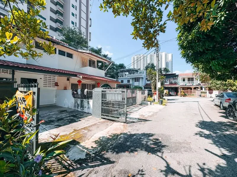 Exterior type: linked terrace house; features: white painted facade, red tiled roof, manicured lawn, paved driveway, gated entrance, surrounded by mature greenery, two-storey structure, adjacent to high-rise buildings, street view, car porch with awning; style: modern.