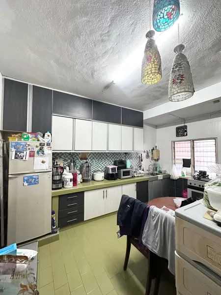 Kitchen features: dark wood cabinetry, white upper cabinets, green countertop, stainless-steel refrigerator, microwave, toaster, coffee machine, built-in oven, 4-burner gas hob, kitchen sink, pendant lights, tile backsplash with geometric pattern, dining table, wooden dining chairs, floor tiles in light green; style: modern.