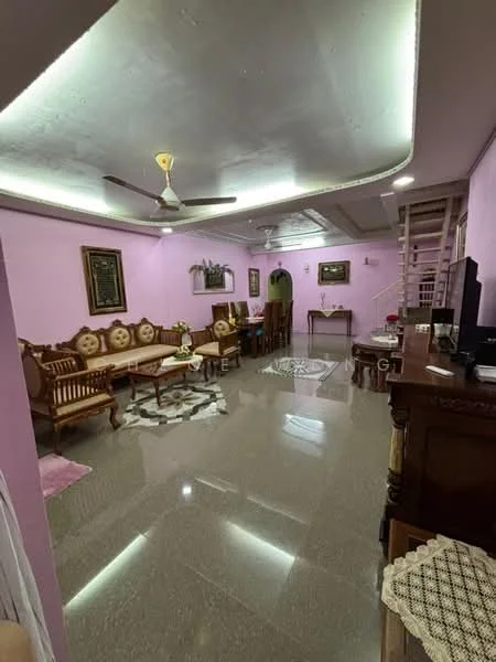 Living features: pink painted walls, polished tile flooring, ceiling with recessed lighting, 5-blade ceiling fan, wooden sofa set with cushions, coffee table, decorative wall art, area rug with geometric pattern, TV console, wall-mounted TV, wooden side table, potted plants, staircase in background; style: traditional.